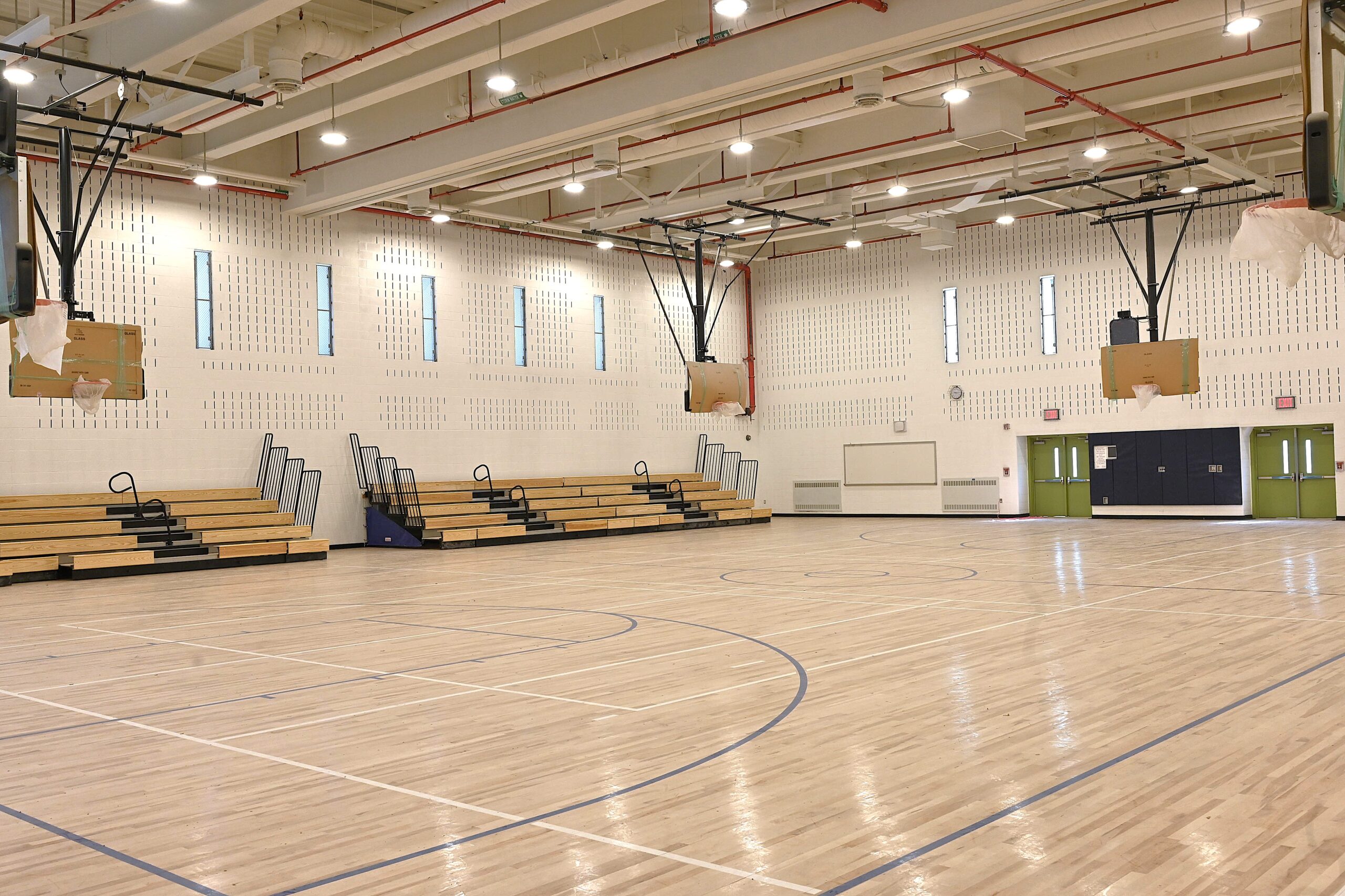 Completed gymnasium interior for NYCSCA high school construction project in Queens