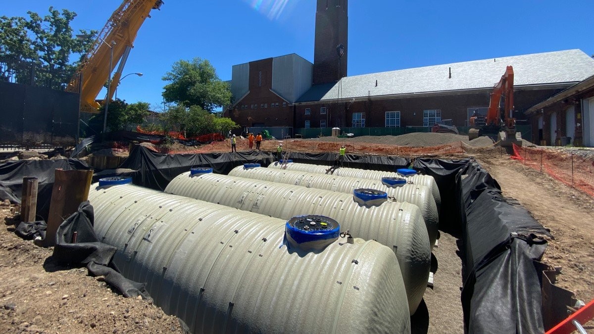 Construction company installing large underground tanks at municipal site